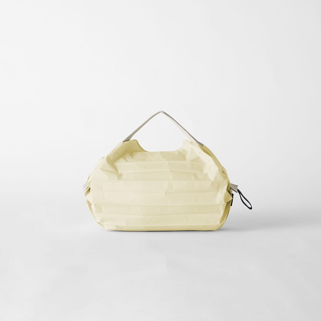 Cashewnut Shupatto S bag with a black elastic band visible at the right side